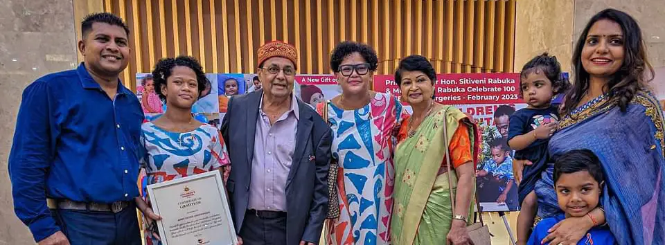 Divine Seva supporters and family members displaying a hospital certificate of gratitude